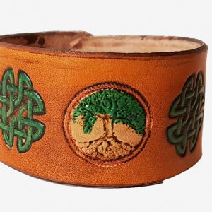 a hand cut leather cuff with tree of life motif and celtic knot stamps