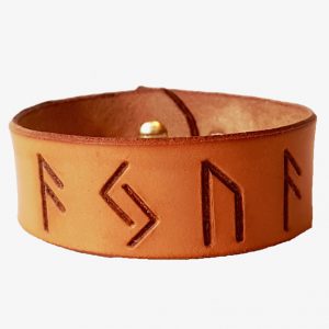 A narrow cuff with AJUA stamped into it in runes made from leather