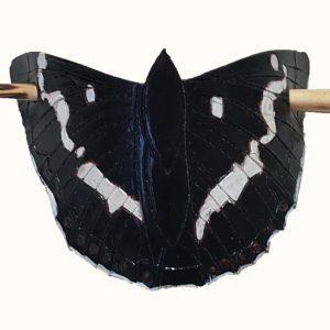 a hand tooled and painted leather hair barrette depicting a white admiral butterfly