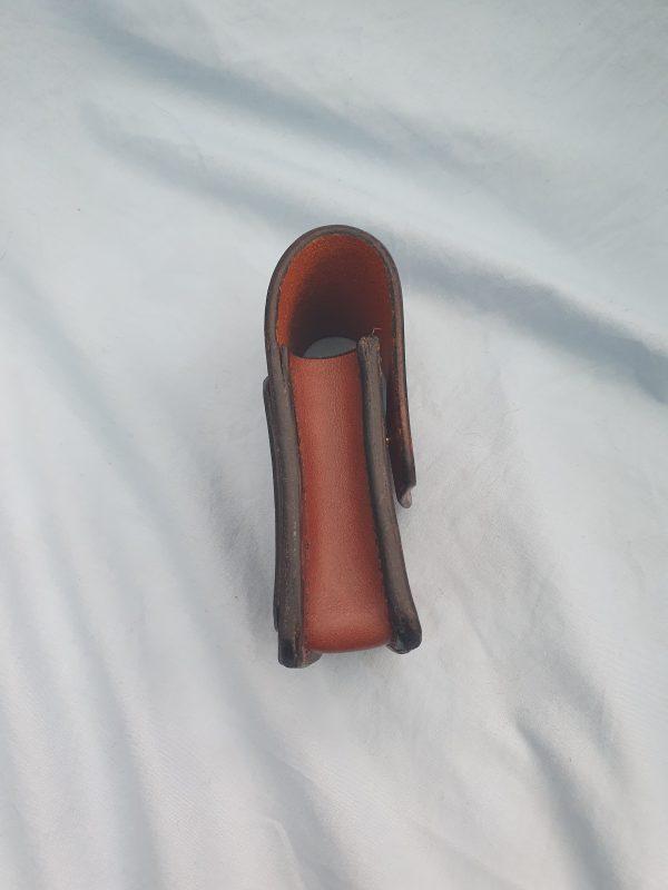 a side view of a small brown leather pouch with a full gusset. the back of the pouch comes over the top to form the flap cover