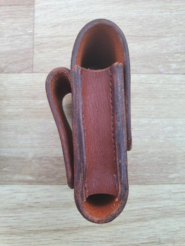 a side view of a brown leather pouch showing the short gusset with a gap at th bottom