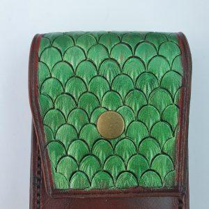 dragon shin tooled leather in green on a brown leather pouch