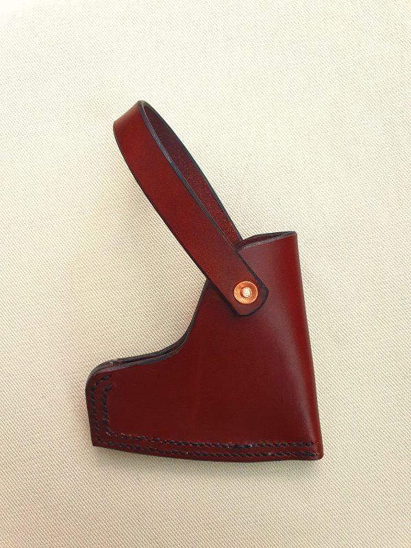 Brown axe sheath with copper rivet on white