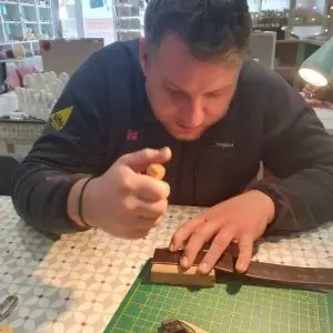 Make a belt course - a man making a leather belt